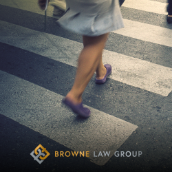 The feet of a Casa Grande pedestrian as they cross the street in a crosswalk
